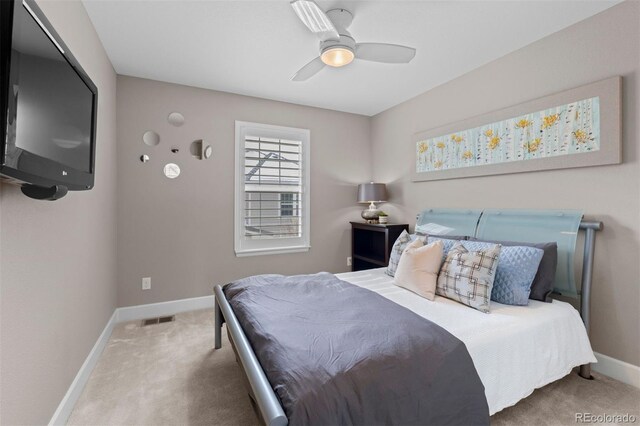 bedroom with carpet floors, baseboards, visible vents, and a ceiling fan