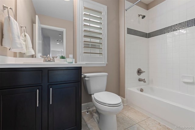 full bath featuring shower / bathtub combination, toilet, vanity, baseboards, and tile patterned floors