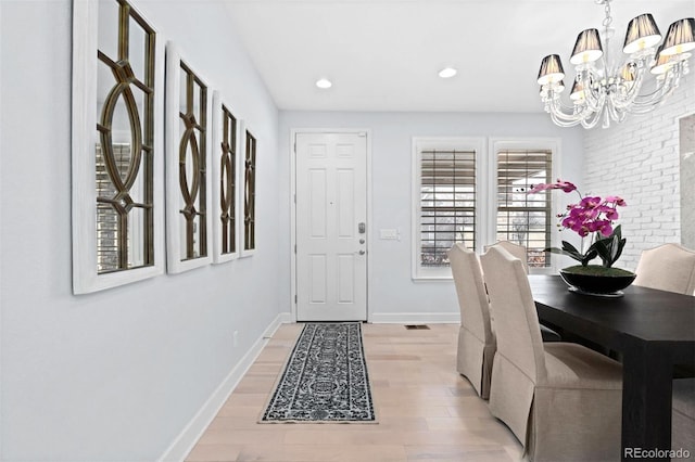 dining area featuring visible vents, baseboards, light wood-style flooring, an inviting chandelier, and recessed lighting