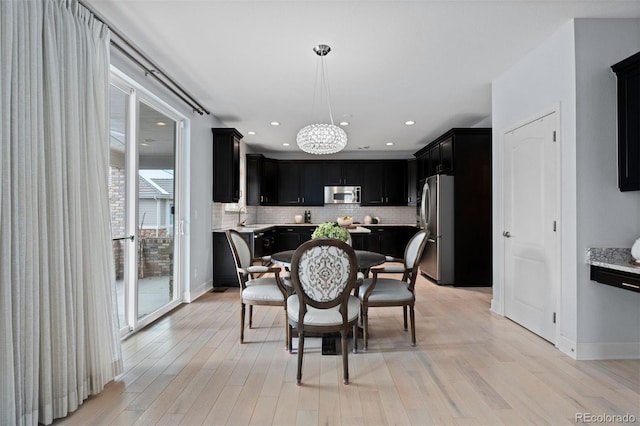 dining area with light wood-type flooring, baseboards, and recessed lighting