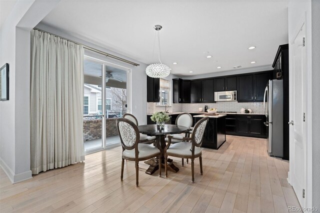 dining room featuring light wood-style flooring and recessed lighting