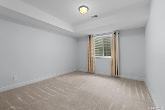 carpeted empty room with visible vents and baseboards