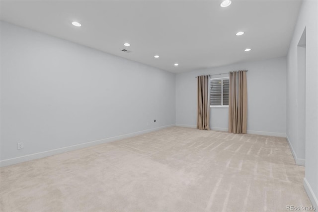 empty room with visible vents, baseboards, light colored carpet, and recessed lighting