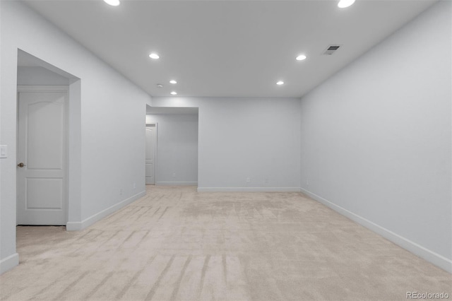 unfurnished room with light carpet, visible vents, and recessed lighting