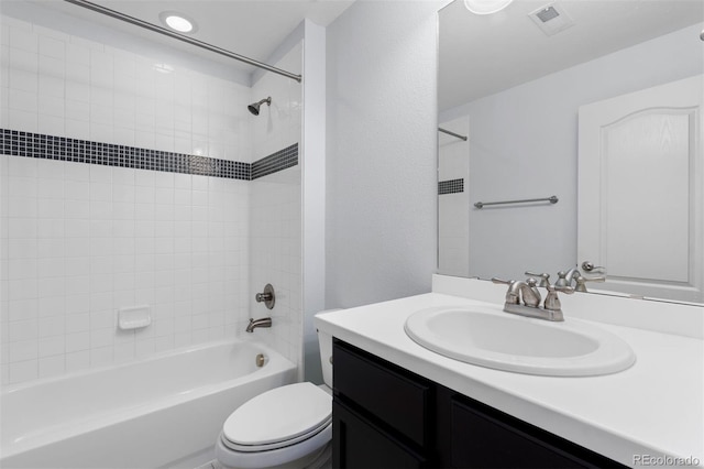 full bathroom featuring shower / washtub combination, visible vents, vanity, and toilet