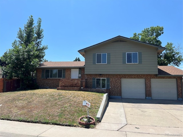 12252 Elmendorf Pl, Denver, CO 80239 - split level home featuring brick siding, concrete driveway, a garage, and a front yard