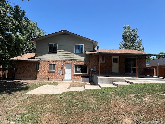 12252 Elmendorf Pl, Denver, CO 80239 - rear view of house with a patio and brick siding