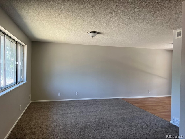 12252 Elmendorf Pl, Denver, CO 80239 - unfurnished room with a textured ceiling and wood finished floors