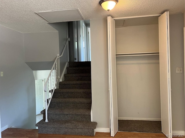 12252 Elmendorf Pl, Denver, CO 80239 - stairs with a textured ceiling and wood finished floors