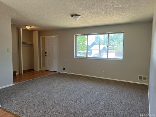 12252 Elmendorf Pl, Denver, CO 80239 - unfurnished bedroom featuring carpet floors, a textured ceiling, and a closet