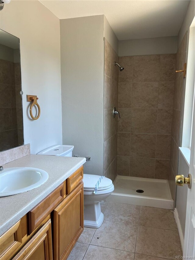 12252 Elmendorf Pl, Denver, CO 80239 - bathroom featuring vanity, tile patterned floors, and a tile shower