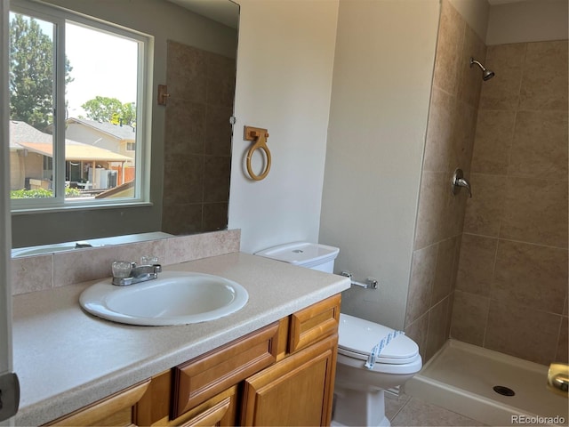 12252 Elmendorf Pl, Denver, CO 80239 - bathroom with vanity, a tile shower, healthy amount of natural light, and tile patterned floors