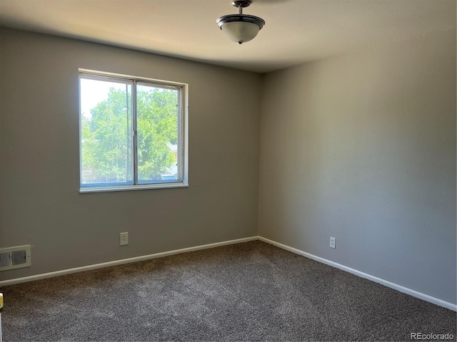 12252 Elmendorf Pl, Denver, CO 80239 - spare room featuring dark carpet and baseboards