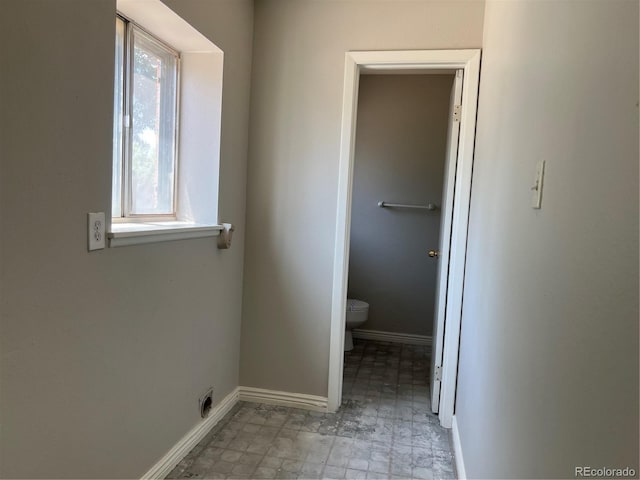 12252 Elmendorf Pl, Denver, CO 80239 - bathroom with toilet and baseboards