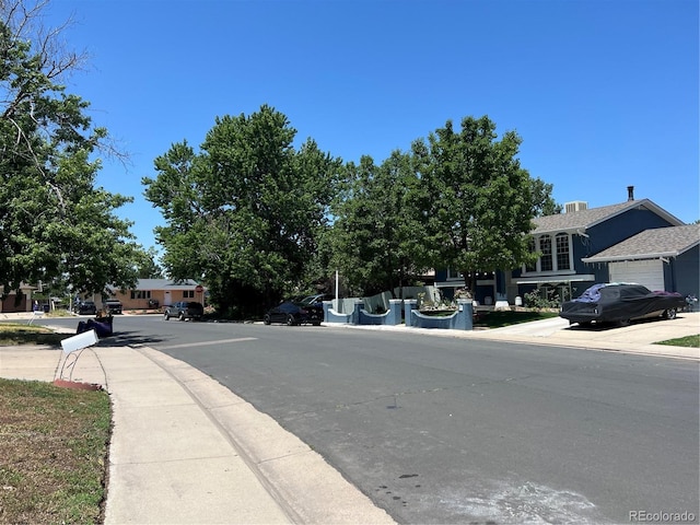 12252 Elmendorf Pl, Denver, CO 80239 - view of asphalt street with sidewalks and curbs