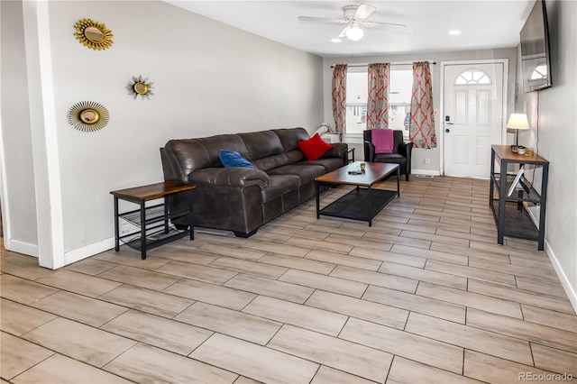 living room with ceiling fan and light wood-type flooring