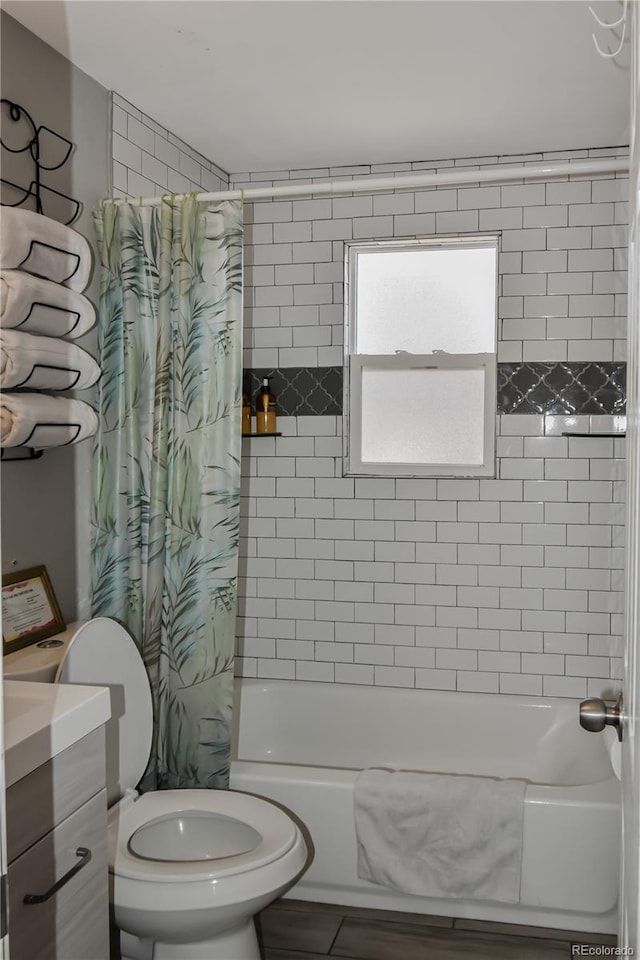 full bathroom with shower / tub combo with curtain, vanity, and toilet