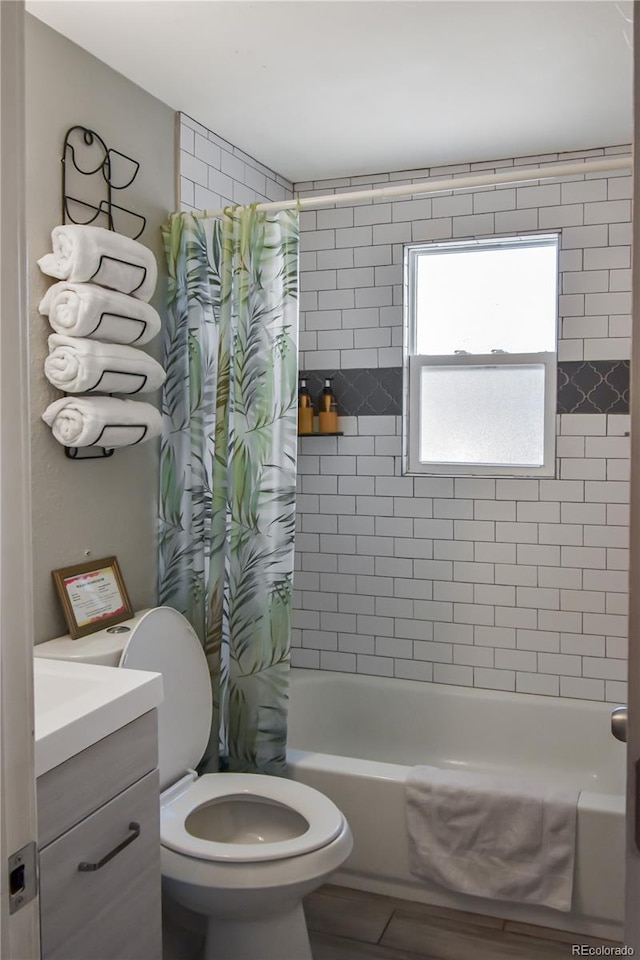 full bathroom with shower / tub combo, vanity, and toilet