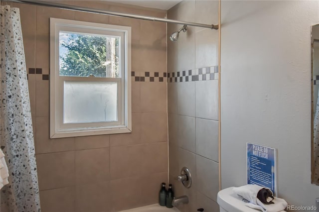 bathroom featuring toilet and shower / bath combo