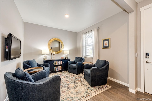 living area with wood finished floors and baseboards