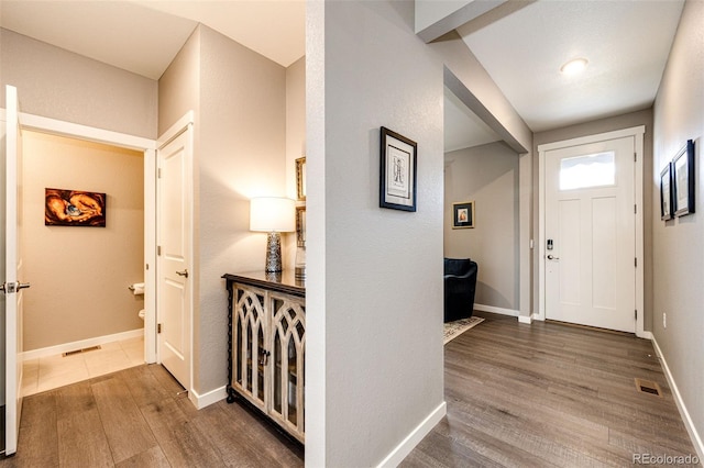 entryway with wood finished floors and baseboards