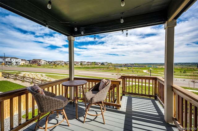 wooden deck with covered porch and a residential view
