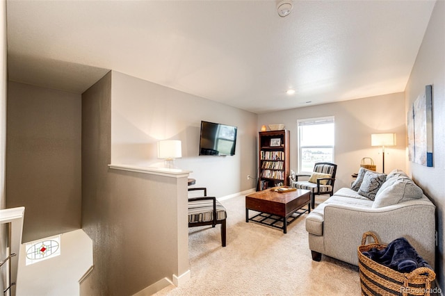 living room featuring light carpet and baseboards