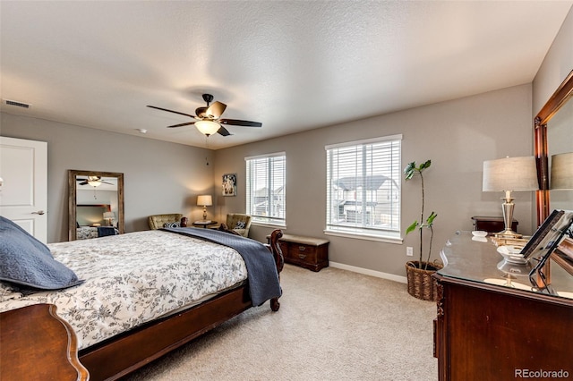 bedroom with light carpet, baseboards, and ceiling fan