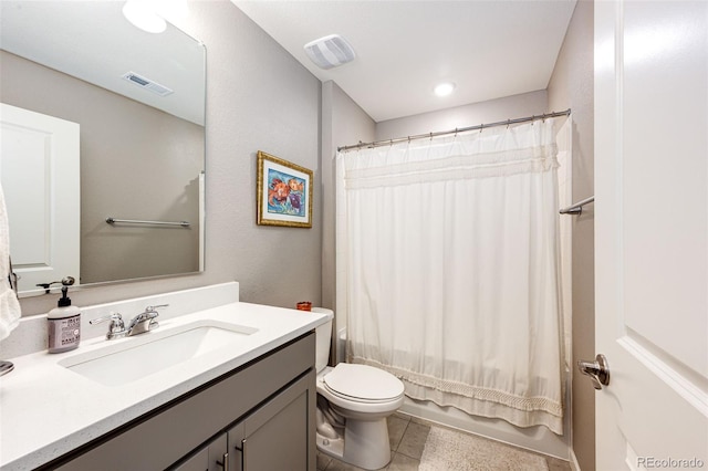 bathroom with toilet, vanity, tile patterned floors, and shower / bath combo