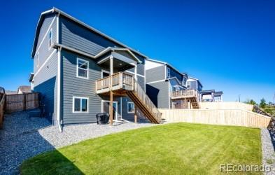17955 Sky Pilot Ave, Parker, CO 80134 - back of house with a fenced backyard, stairway, and a deck