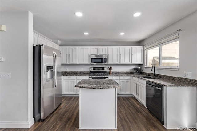 kitchen featuring white cabinetry, sink, a center island, and appliances with stainless steel finishes