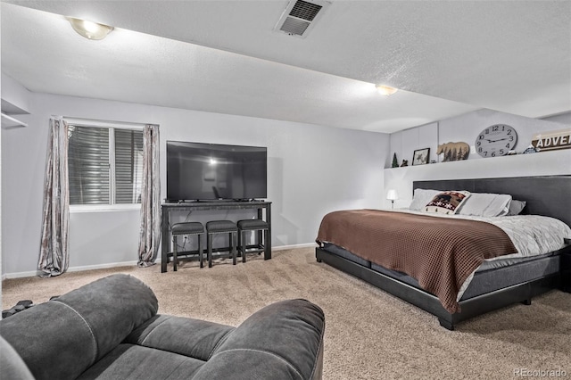 bedroom with a textured ceiling and carpet