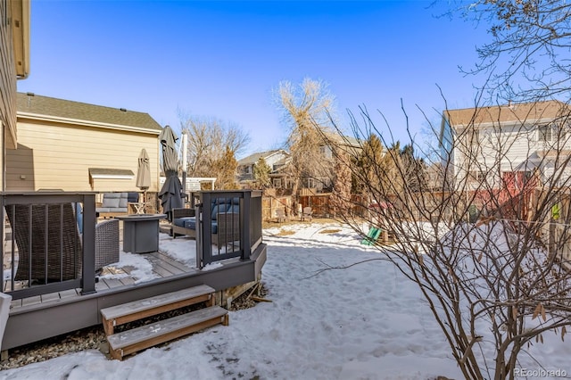 snowy yard featuring a wooden deck