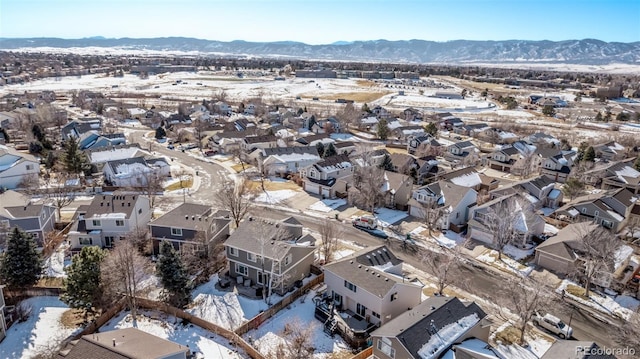 snowy aerial view with a mountain view