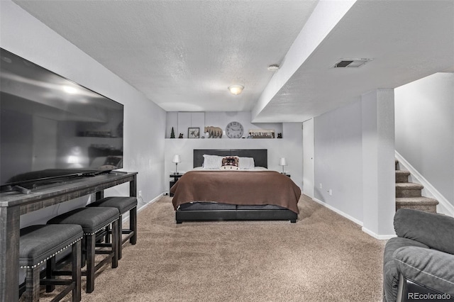 carpeted bedroom featuring a textured ceiling