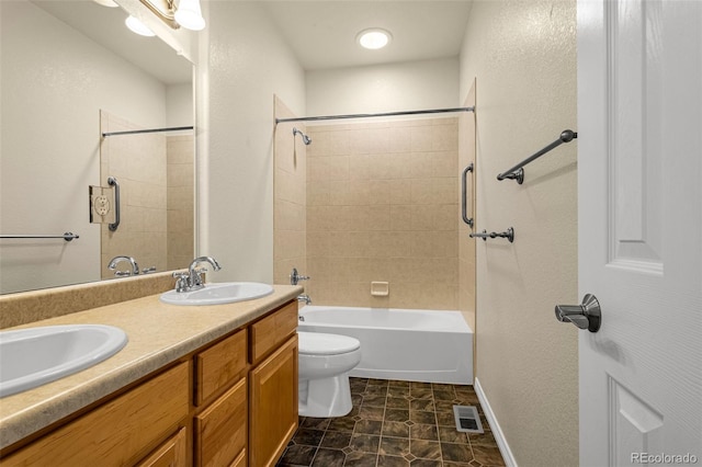 full bath featuring toilet, double vanity, visible vents, and a sink