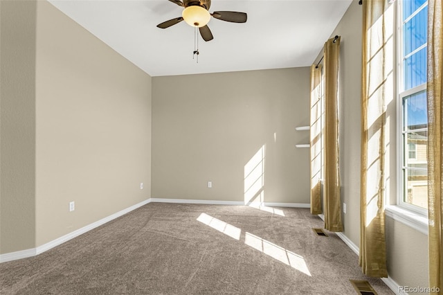 unfurnished room with baseboards, visible vents, ceiling fan, and carpet flooring