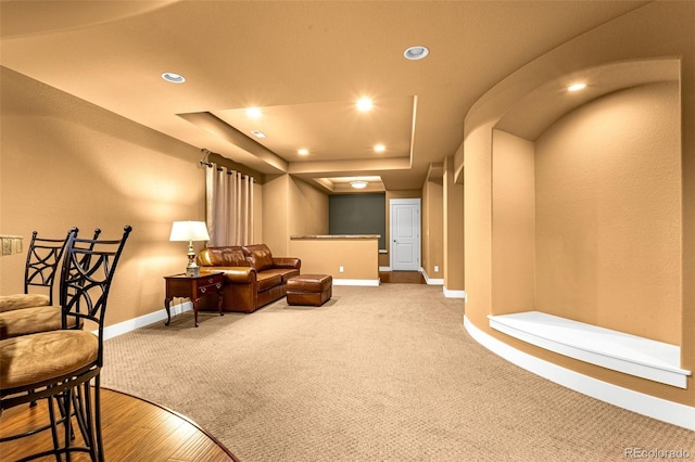 carpeted cinema room with baseboards, a tray ceiling, and recessed lighting