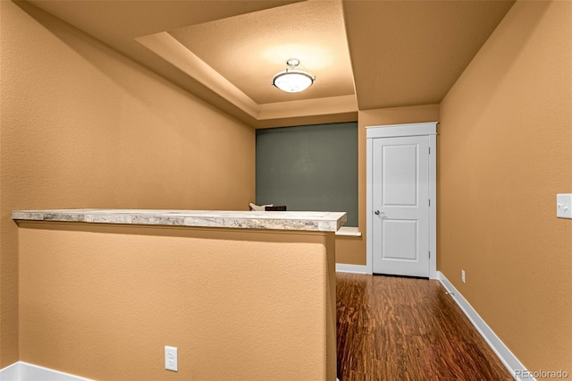 interior space with baseboards and dark wood finished floors