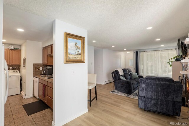 13 Nome Way Unit A, Aurora, CO 80012 - living room with baseboards, baseboard heating, recessed lighting, and washer / clothes dryer