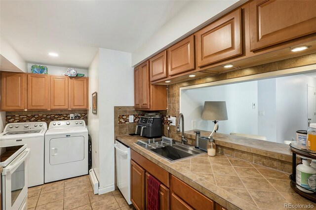 13 Nome Way Unit A, Aurora, CO 80012 - kitchen featuring decorative backsplash, brown cabinetry, dishwasher, a sink, and separate washer and dryer