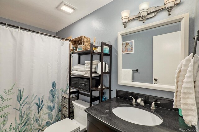 13 Nome Way Unit A, Aurora, CO 80012 - bathroom featuring vanity, visible vents, toilet, and a shower with curtain