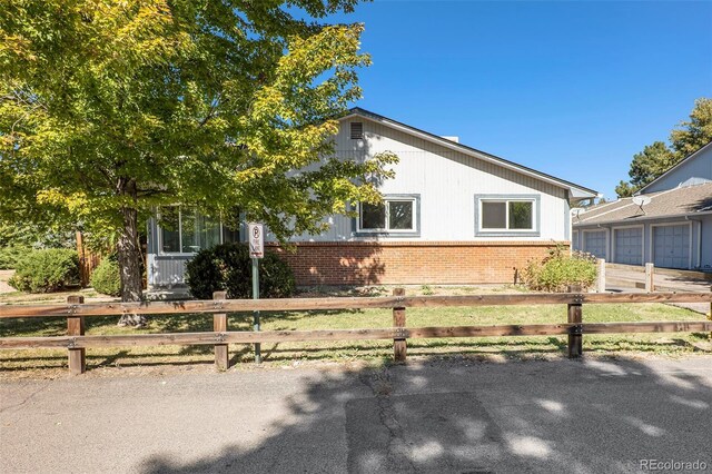 13 Nome Way Unit A, Aurora, CO 80012 - view of home's exterior with brick siding, a fenced front yard, and a garage