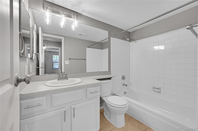 bathroom featuring tile patterned floors, toilet, vanity, and washtub / shower combination