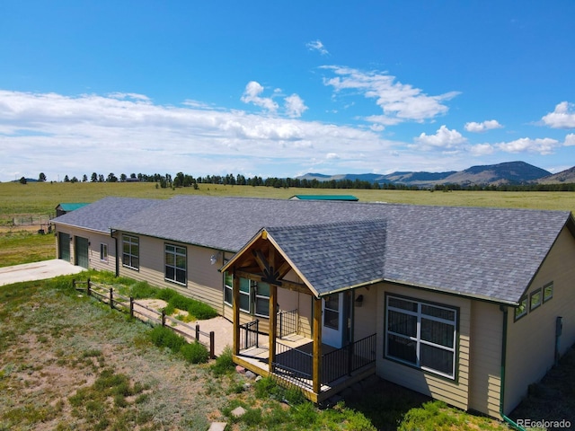 view of front of house featuring a mountain view and a rural view