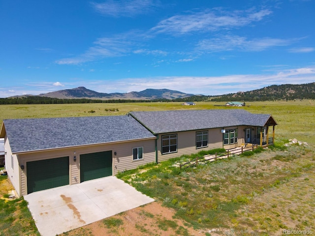 single story home with a garage and a mountain view