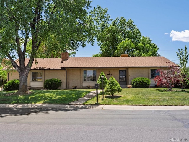 3780 W 66th Ave, Arvada, CO 80003 - ranch-style house featuring a chimney, a front yard, and brick siding