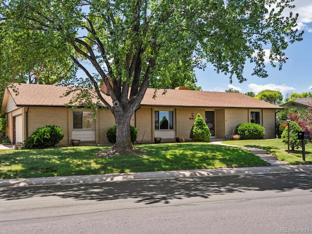 3780 W 66th Ave, Arvada, CO 80003 - ranch-style home with brick siding, a front yard, and a garage