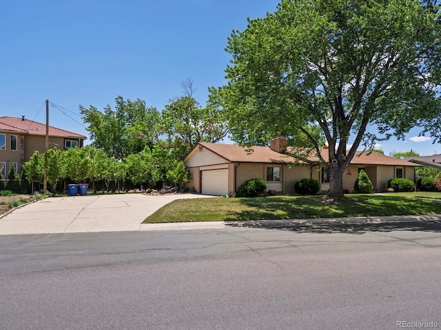 3780 W 66th Ave, Arvada, CO 80003 - view of front of house with a garage, a front yard, concrete driveway, and brick siding