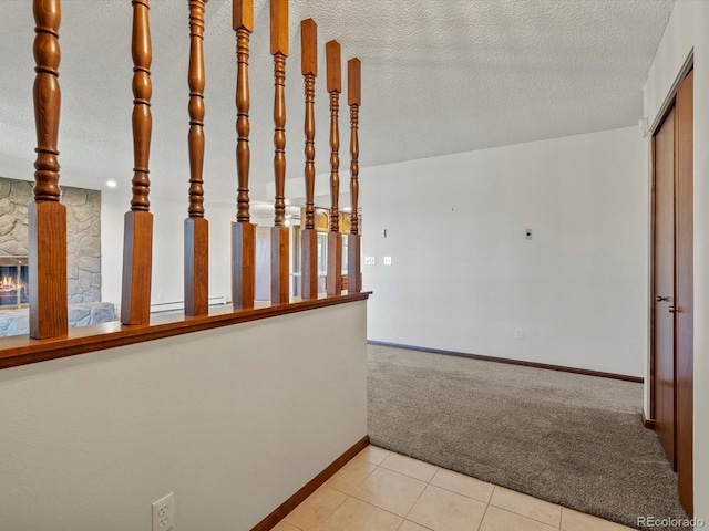 3780 W 66th Ave, Arvada, CO 80003 - corridor with carpet, baseboards, a textured ceiling, and tile patterned flooring